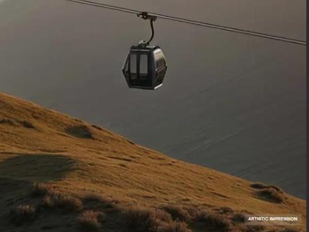 Queenstown Cable Car — gondola on the cable above tussock slopes and Lake Wakatipu